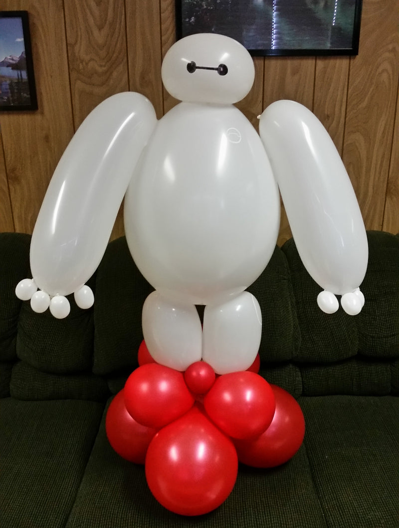 Balloon sculpture of a rabbit with a red bow tie on a dark surface.2