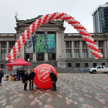 Load image into Gallery viewer, Red and white helium balloon arch 50ft for the Salvation Army Fundraiser event by Vancouver Balloons
