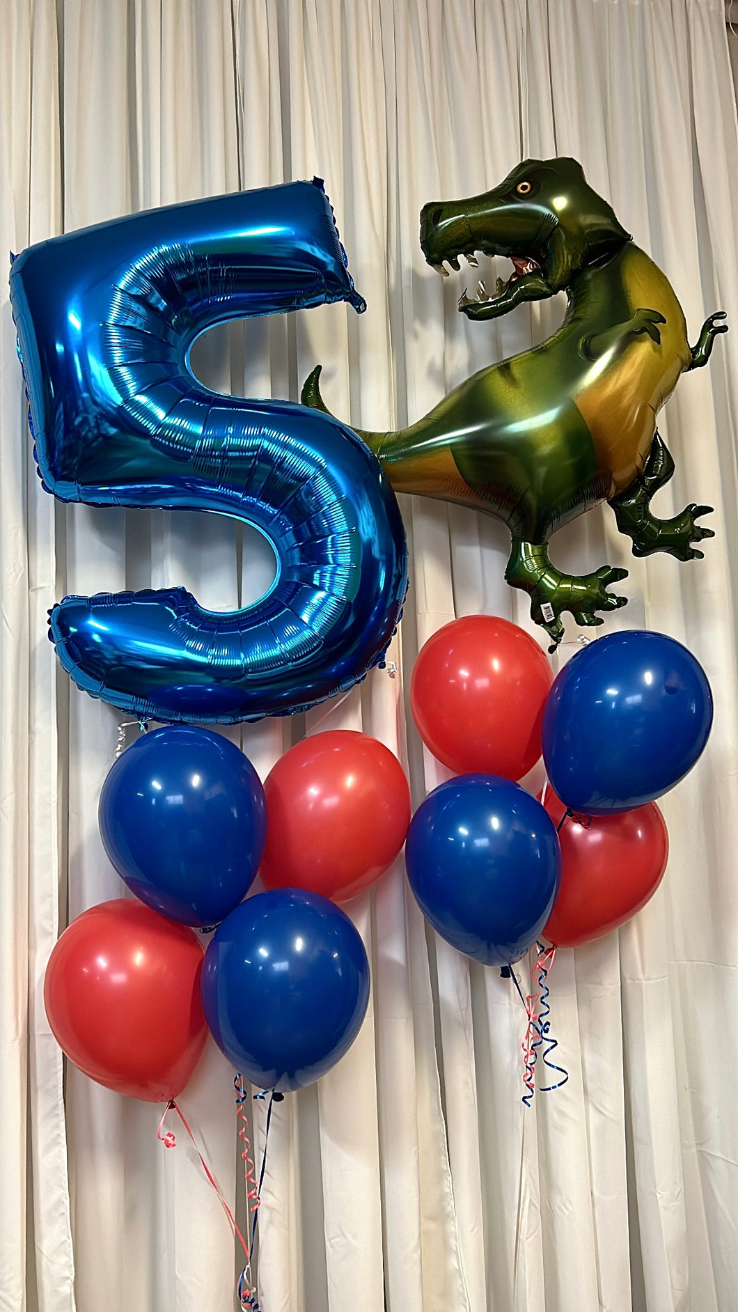 blue foil number balloons with dinosaur mylar balloon and red and blue ballons