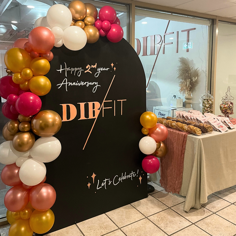 handwritten black balloon backdrop with gold pink white balloons6
