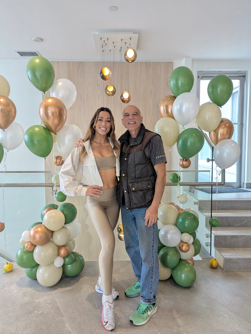 green and gold Hybrid balloon columns with people posing 3