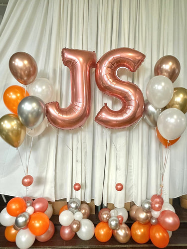 rose gold letter balloons with orange and gold balloon bouquets