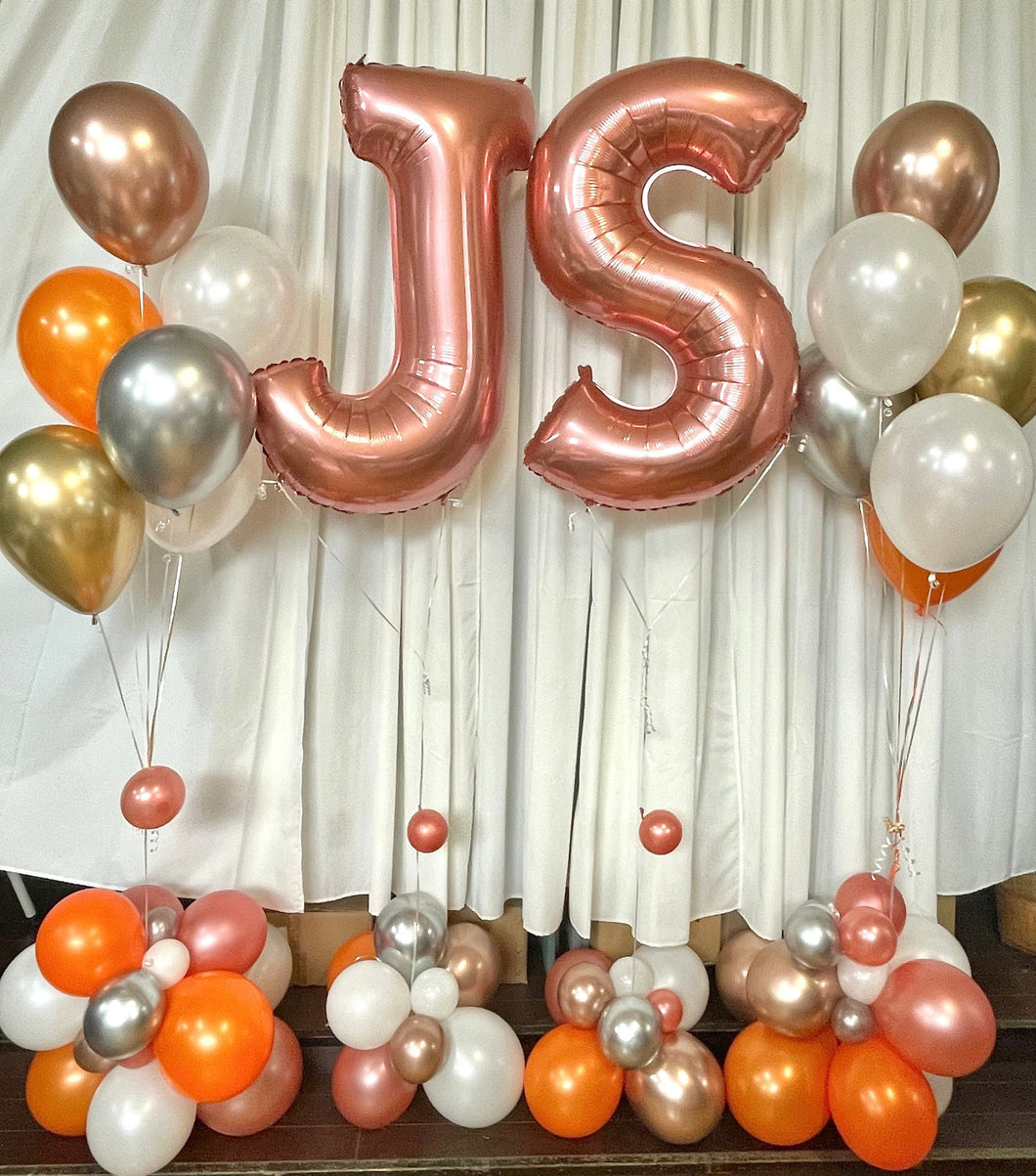 rose gold letter balloons with orange and gold balloon bouquets