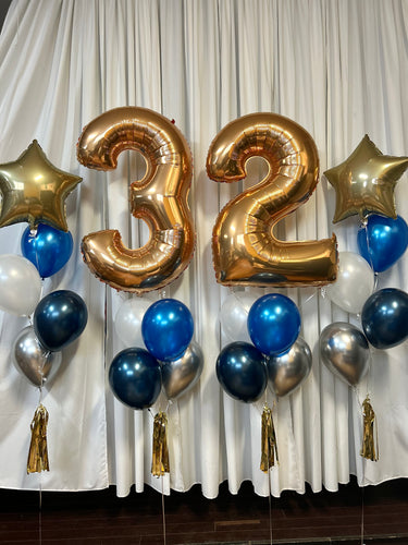 gold number balloons with chrome blue and silver balloon bouquets and a star mylar balloon