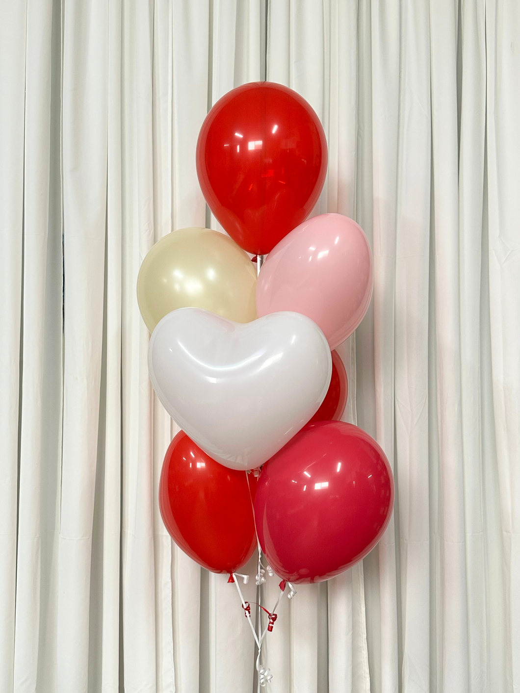red balloons heart shaped balloon bouquet