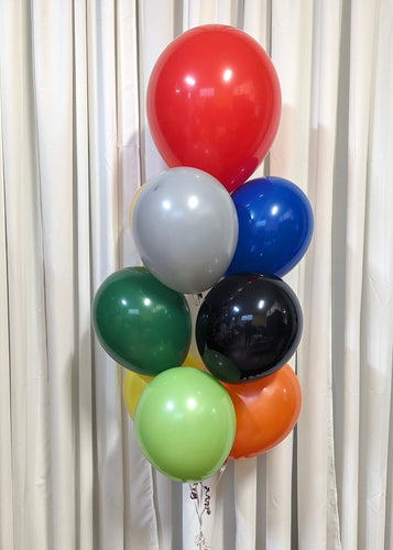 A colorful balloon bouquet featuring a variety of colors including red, gray, blue, black, green, orange, white, and yellow, arranged in a loop shape.