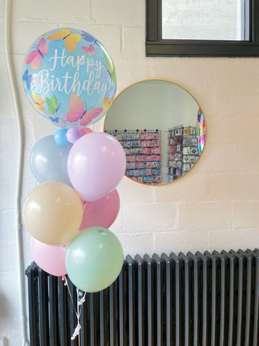butterfly birthday bubble balloon with pastel colored latex balloons