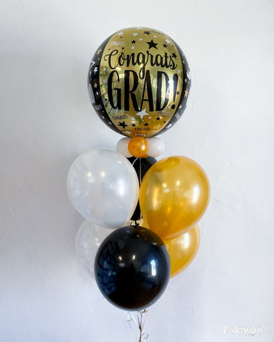graduation balloon bouquet with gold and black balloons
