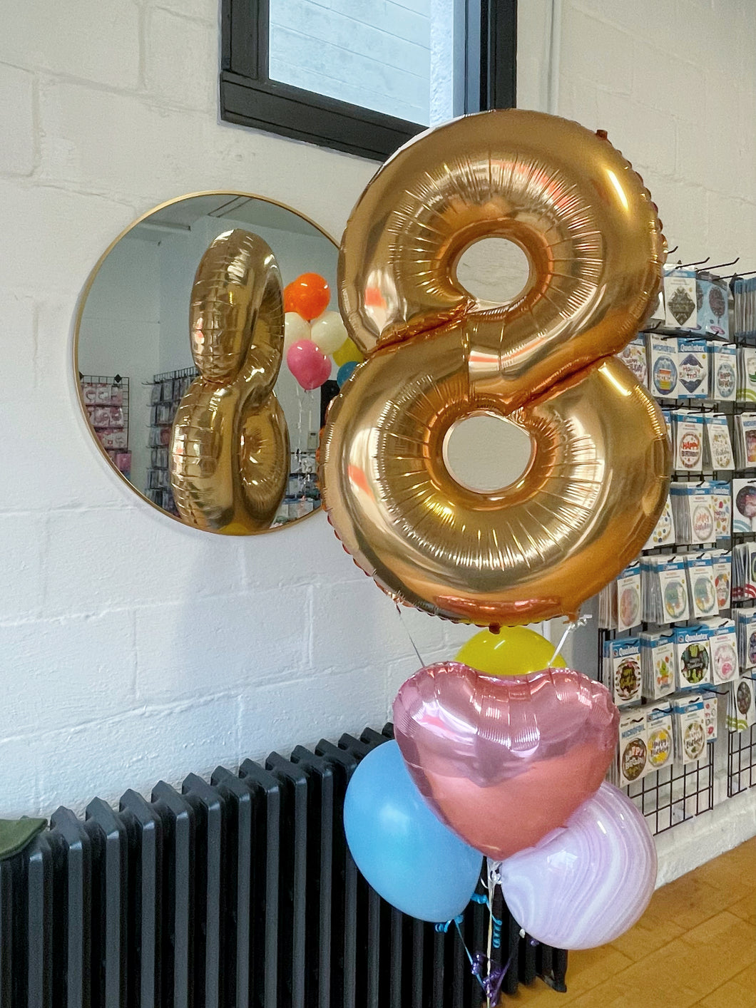gold foil number balloon with pink heart foil balloon and latex balloons